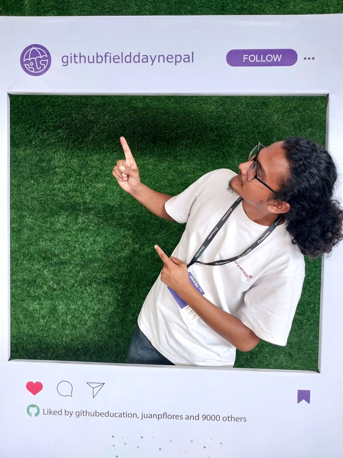 Hikmat posing inside a large photo frame at GitHub Field Day Nepal